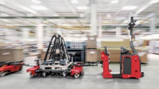 Industrial trucks from Linde Material Handling moving around in a warehouse.