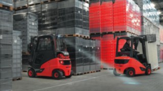 Linde forklift with LED spotlight Linde forklift with LED spotlight driving in a warehouse with load