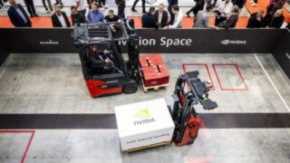 Two vehicles from Linde Material Handling transport loads at LogiMAT 2025.
