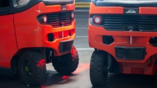 Rear view of two Linde E20 counterbalance forklifts, equipped with the Linde Reverse Assist Radar.