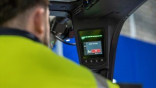 A display in the driver's cabin shows a warning notification by the Linde Reverse Assist Radar.