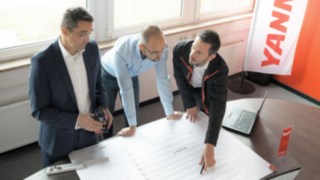 Experts from Linde Material Handling in action at Yanmar Compact Equipment Europe. Experts from Linde Material Handling join forces to plan the Yanmar Compact Equipment Europe logistics centre.