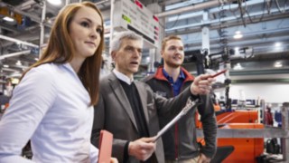Image of staff in front of a truck Image of staff in front of a truck
