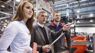 Image of staff in front of a truck