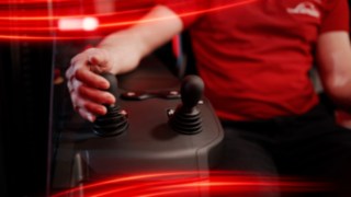 Hand operating joysticks in the reach truck Ri16 by Linde MH