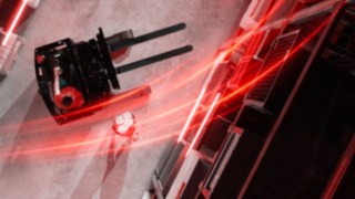 Linde MH reach truck Ri16 from a bird’s-eye view with red light trails, next to a person doing a handstand.