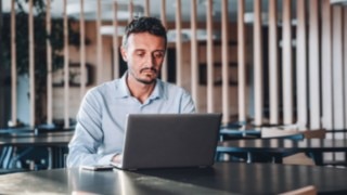 A project manager focuses on managing projects on his laptop in an international environment at Linde. 